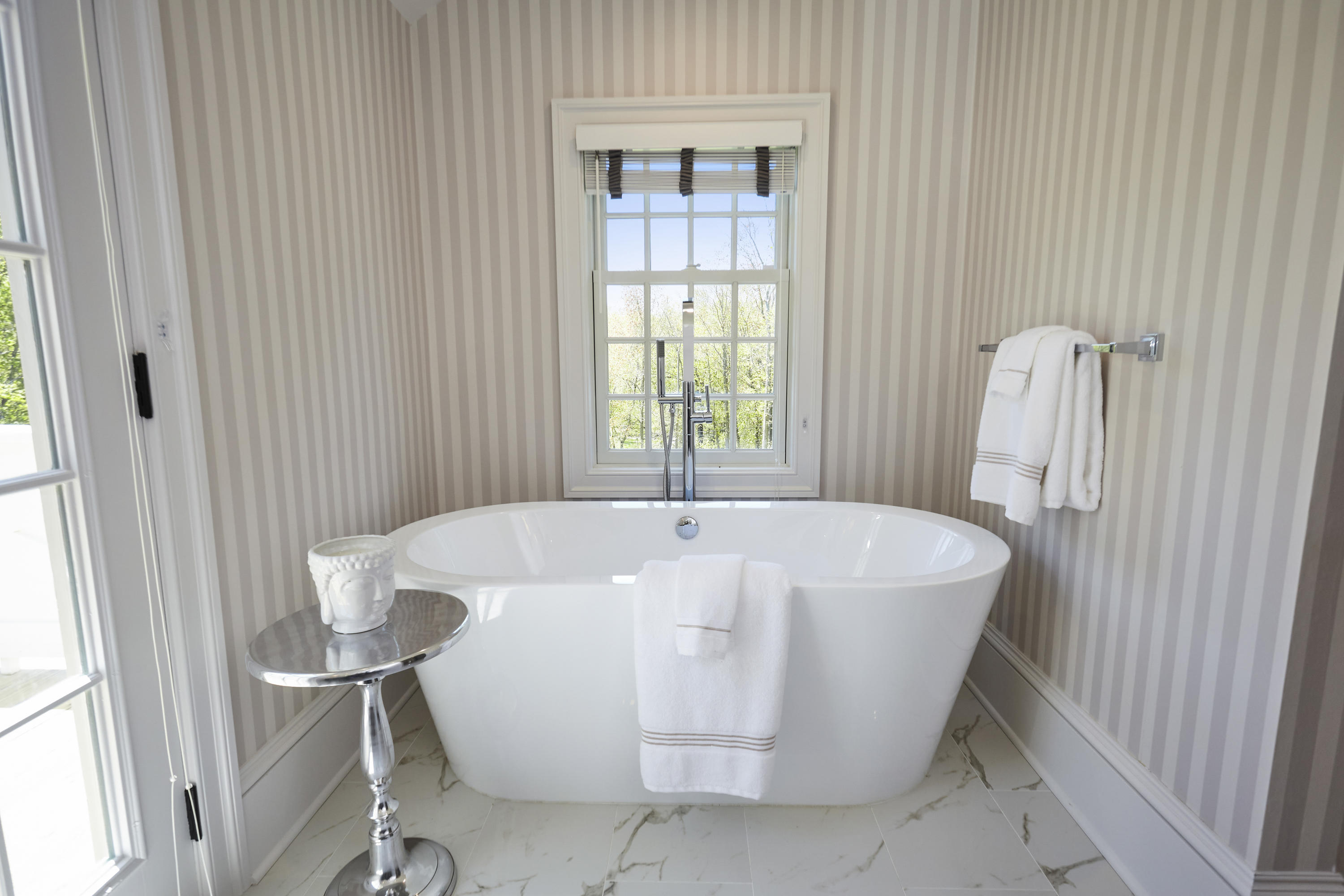 756 Ponus Ridge Road New Canaan, CT 06840 - Photo 23 of 54 a white bath tub sitting in a bathroom next to a window