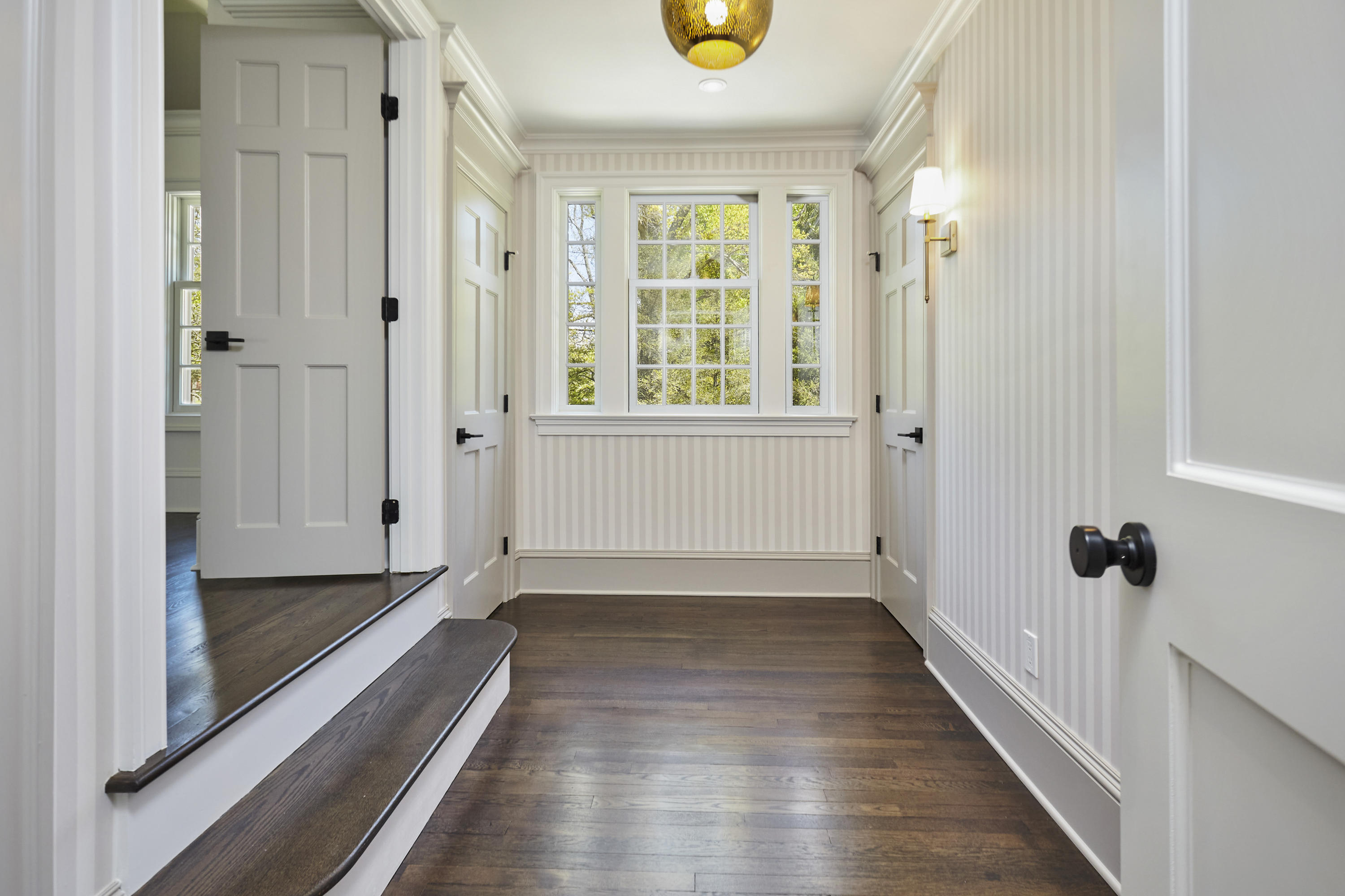 756 Ponus Ridge Road New Canaan, CT 06840 - Photo 26 of 54 a view of a hallway with wooden floor and a bathroom