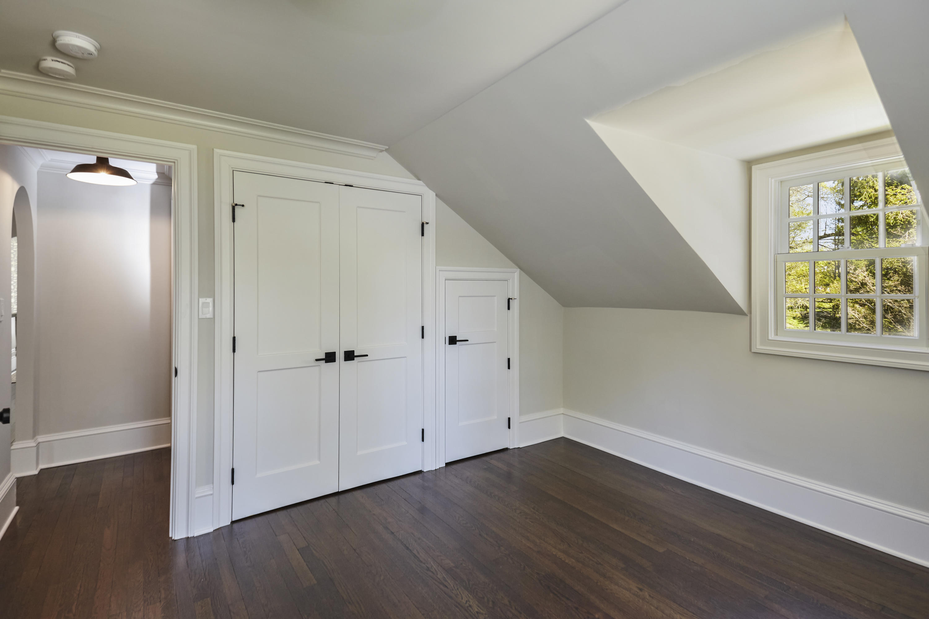 756 Ponus Ridge Road New Canaan, CT 06840 - Photo 30 of 54 a view of an empty room with wooden floor and a window