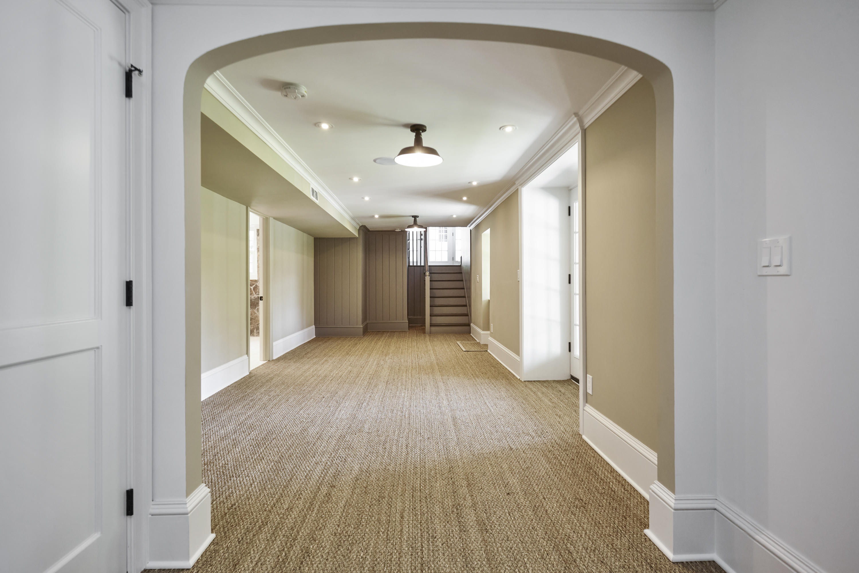 756 Ponus Ridge Road New Canaan, CT 06840 - Photo 34 of 54 a view of a hallway with wooden floor and a ceiling fan