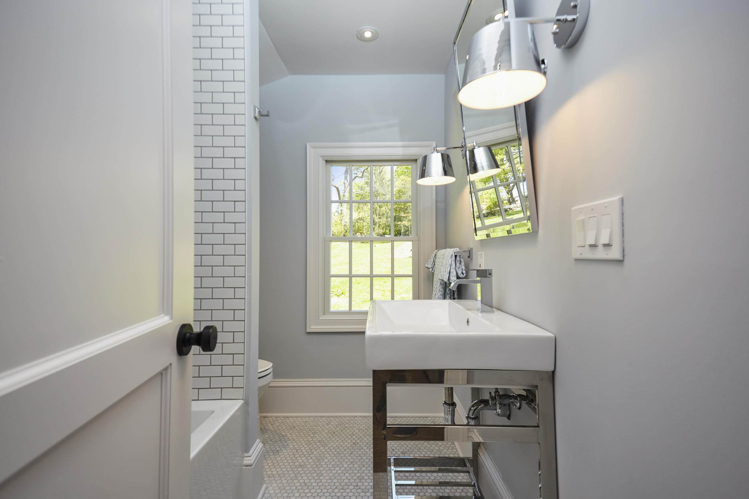 756 Ponus Ridge Road New Canaan, CT 06840 - Photo 43 of 54 a bathroom with a sink a bathtub and a window