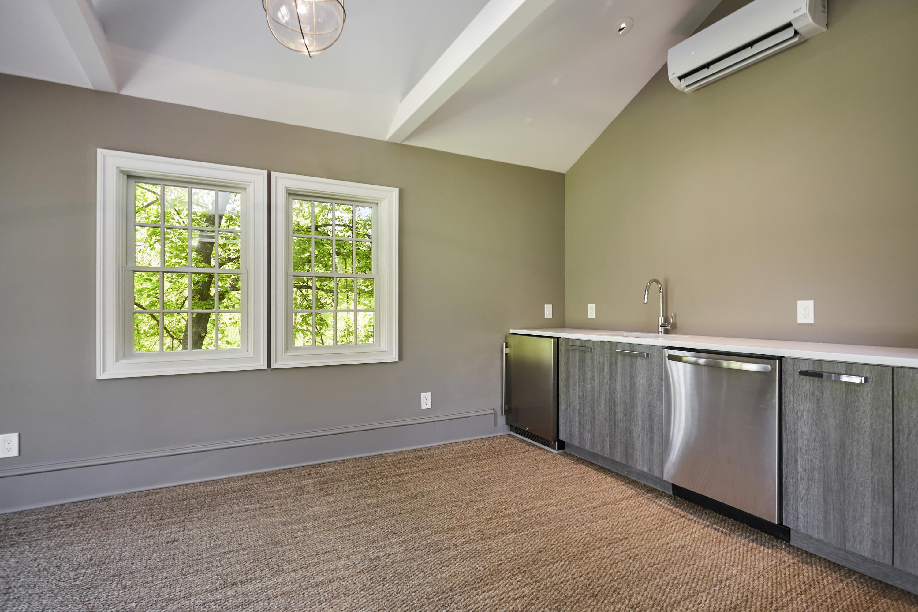 756 Ponus Ridge Road New Canaan, CT 06840 - Photo 53 of 54 a view of an empty room with wooden floor and a window