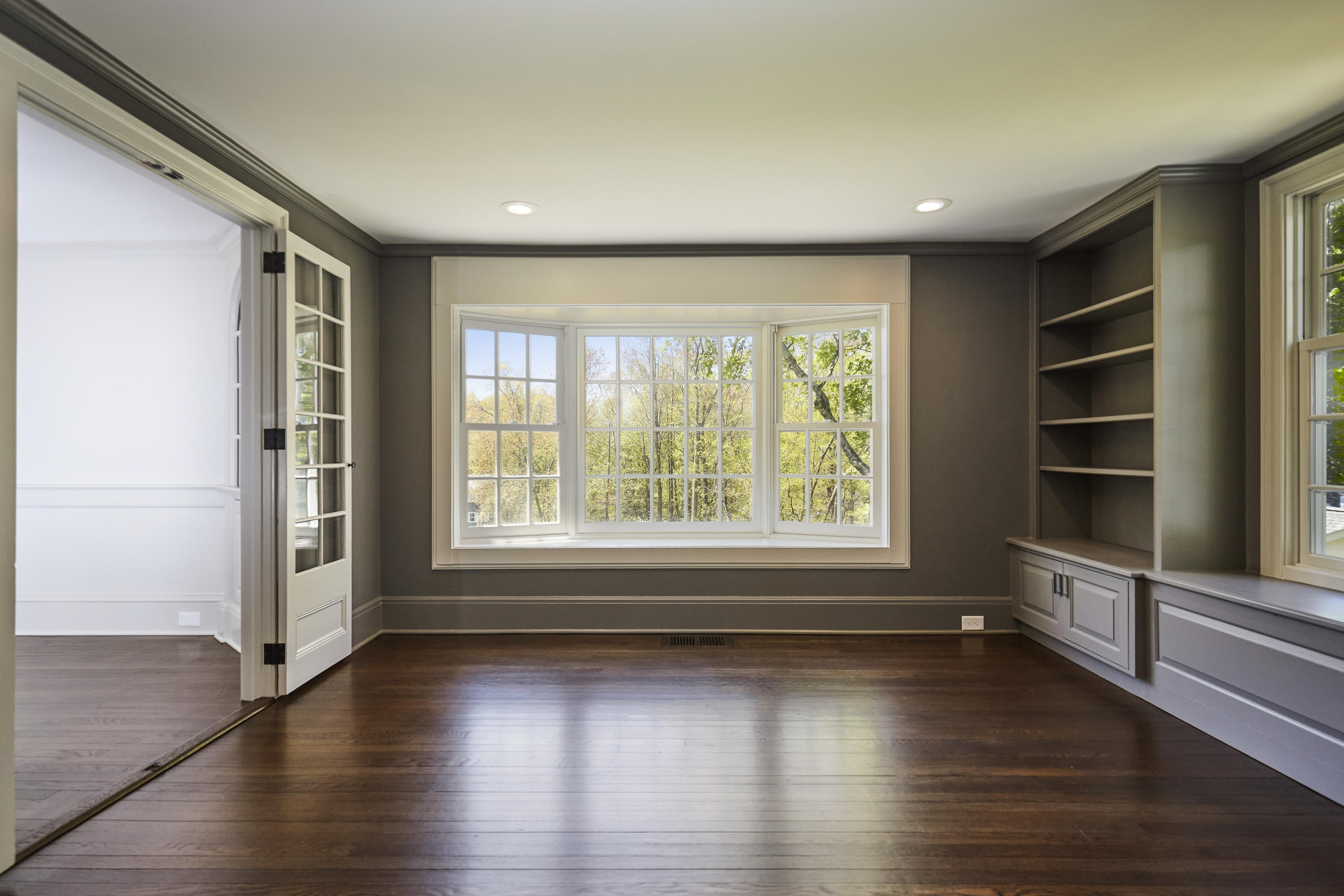 756 Ponus Ridge Road New Canaan, CT 06840 - Photo 7 of 54 an empty room with wooden floor and windows