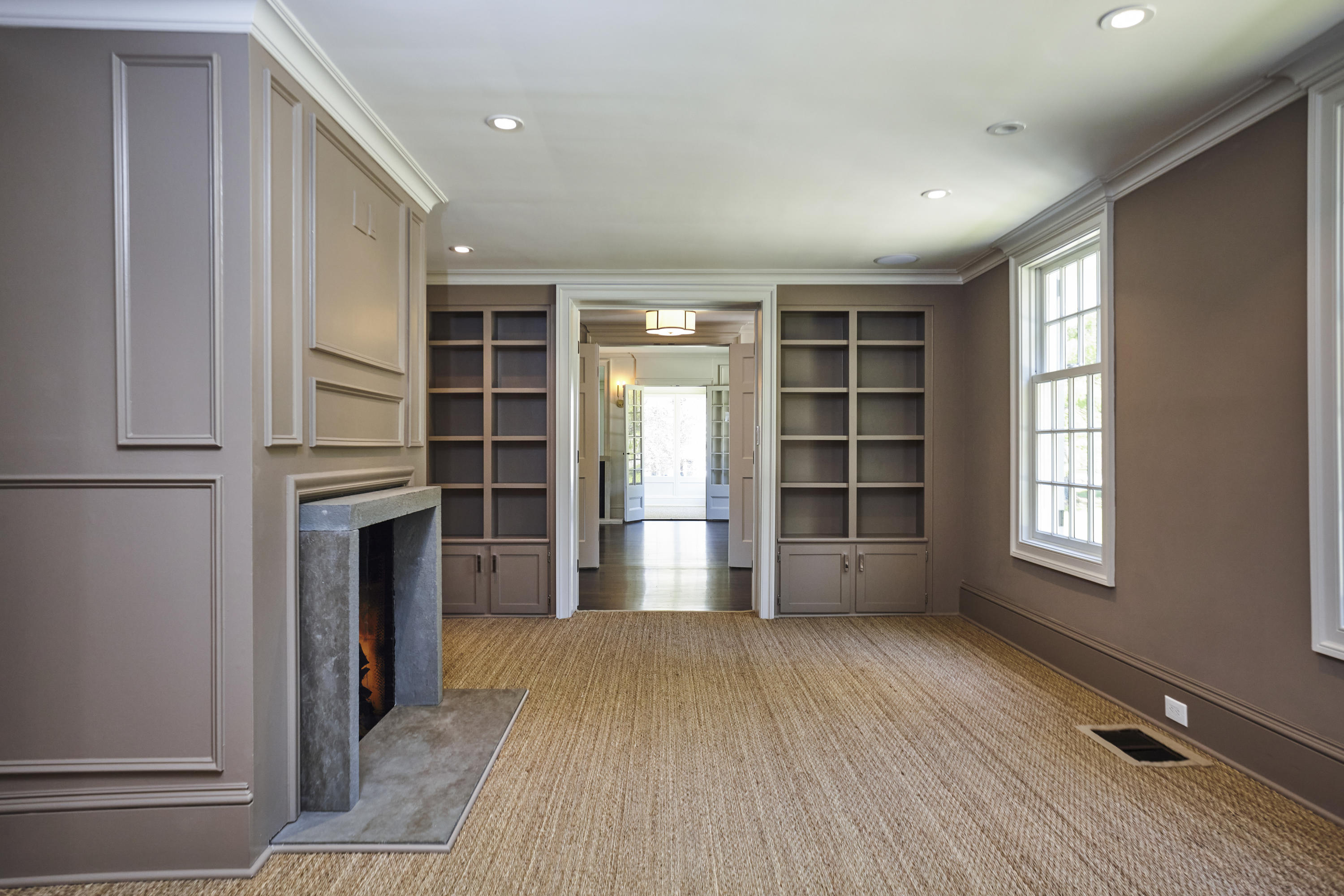 756 Ponus Ridge Road New Canaan, CT 06840 - Photo 9 of 54 an empty room with a fireplace and windows