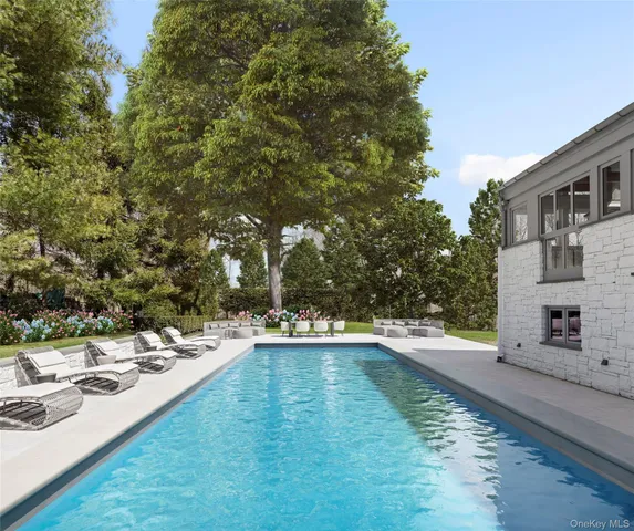 a view of a swimming pool and lounge chairs