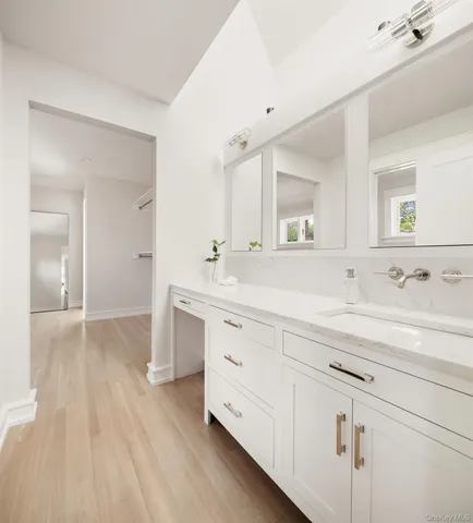 a spacious bathroom with a double vanity sink and mirror