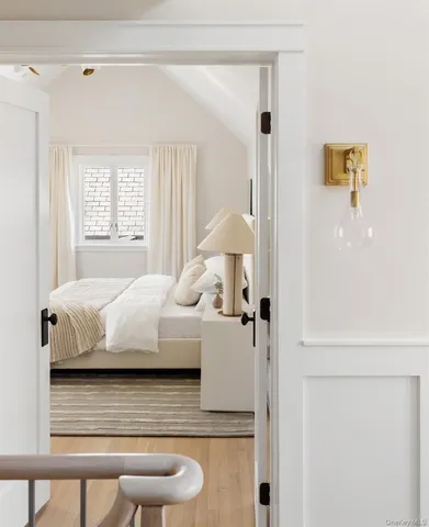 a bedroom with a bed and a lamp