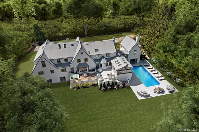 an aerial view of a house with a garden and lake view