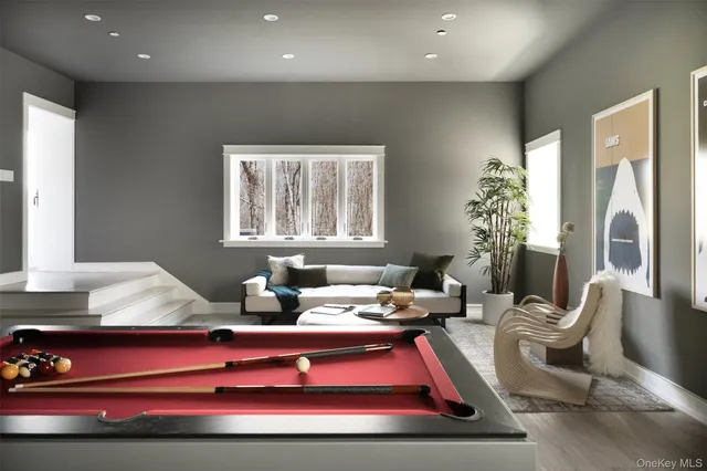 a room with furniture pool table and window