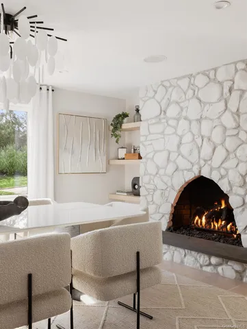 a living room with a fireplace and a floor to ceiling window