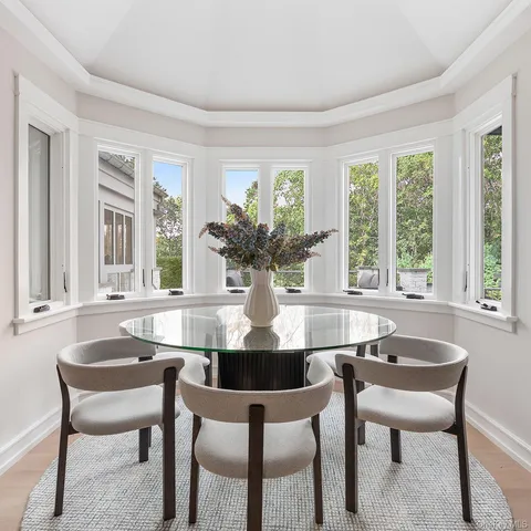 a view of a dining room with furniture and window