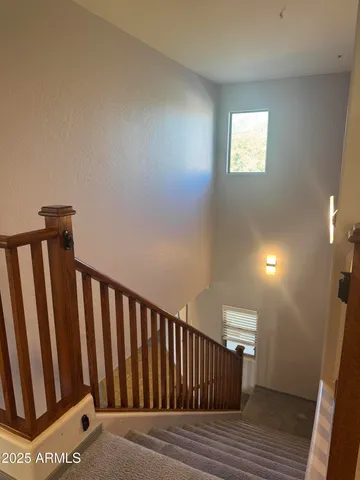 a view of a hallway with wooden floor and stairs
