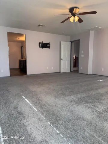 a view of an empty room with a ceiling fan
