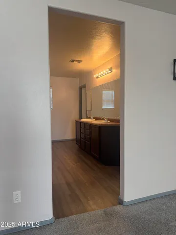a en suite bathroom with a sink and a mirror