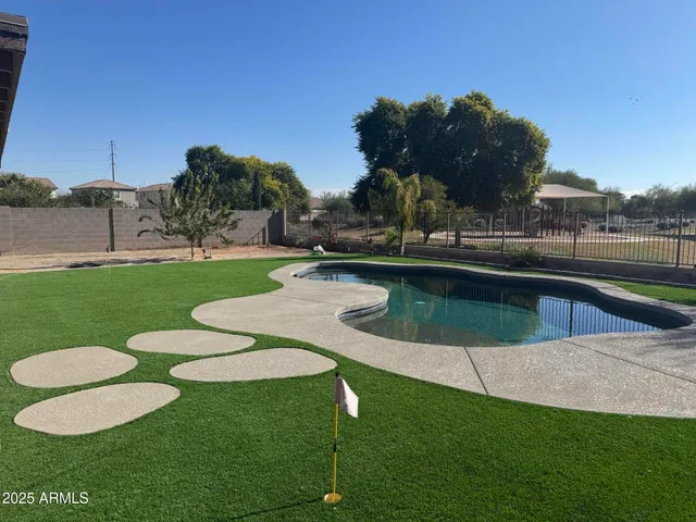 a view of a swimming pool and lounge chairs