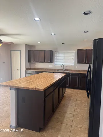 a large kitchen with stainless steel appliances and a sink