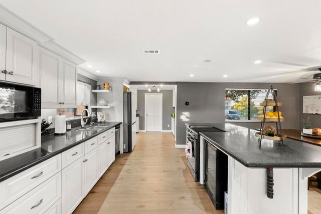 a spacious bedroom with a bed and a chandelier