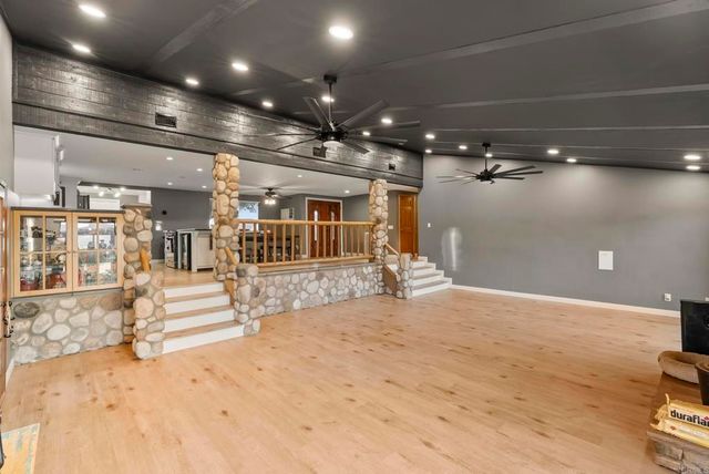 a bedroom with a bed and a flat tv screen on the dresser