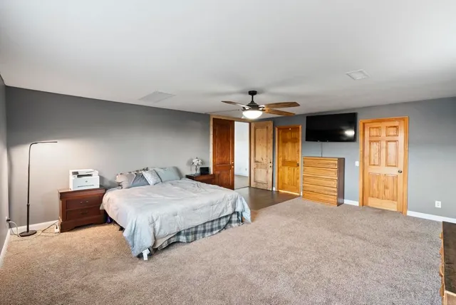 a living room with furniture a large window and a flat screen tv