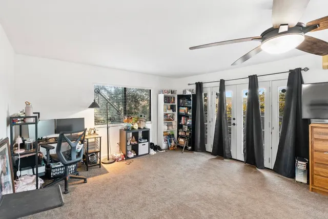an aerial view of residential houses with outdoor space and trees