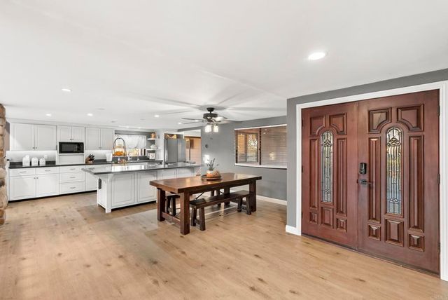 a kitchen with a refrigerator and a sink