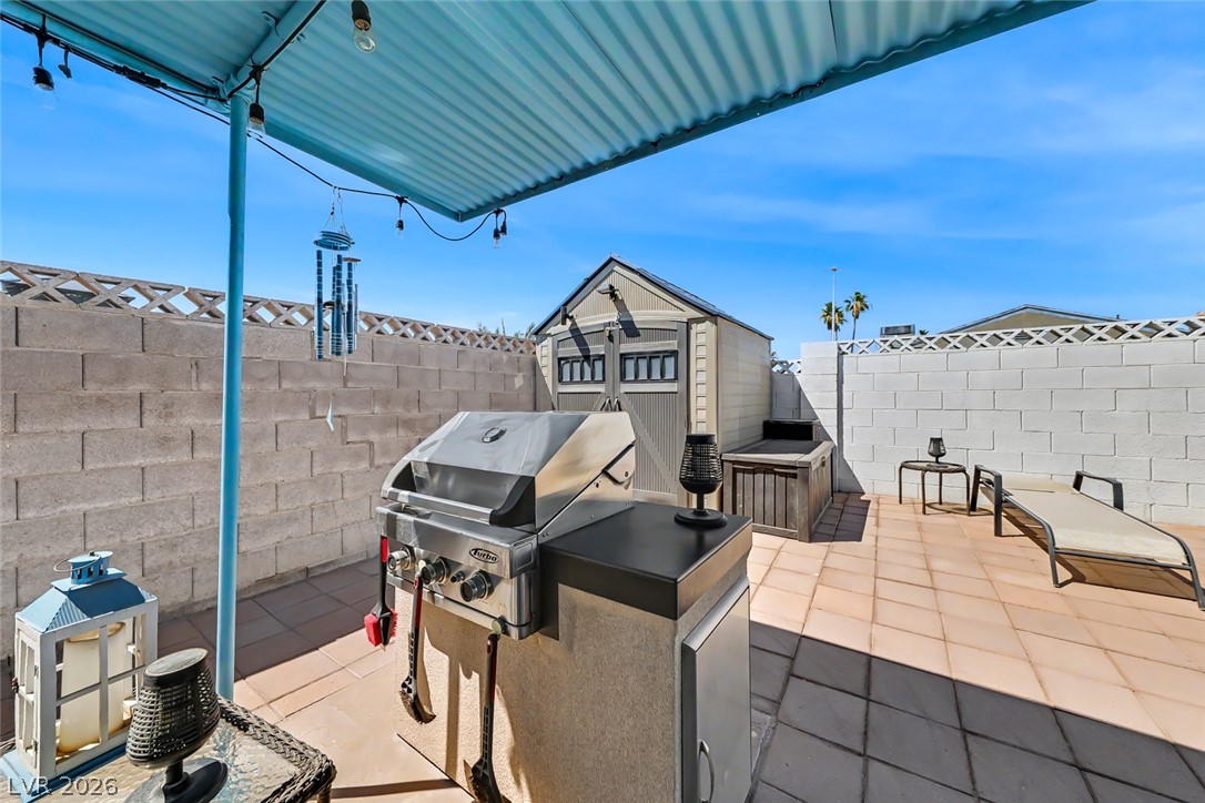3107 Trueno Road Henderson, NV 89014 - Photo 30 of 37 A private patio space with a built-in barbecue station for outdoor entertaining.