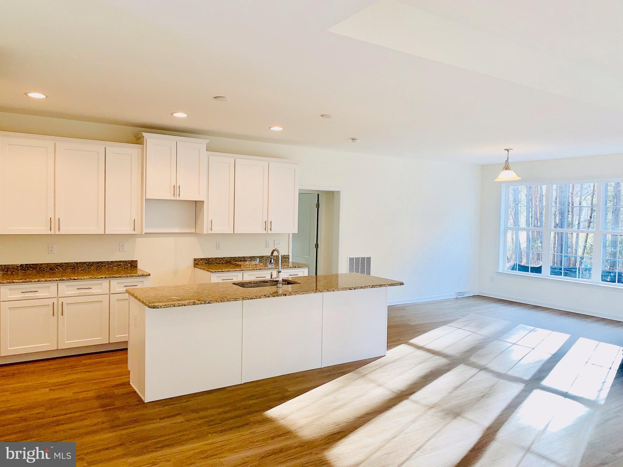 10 Patriots Way Georgetown, DE 19947 - Photo 19 of 56 a large kitchen with granite countertop a sink and cabinets