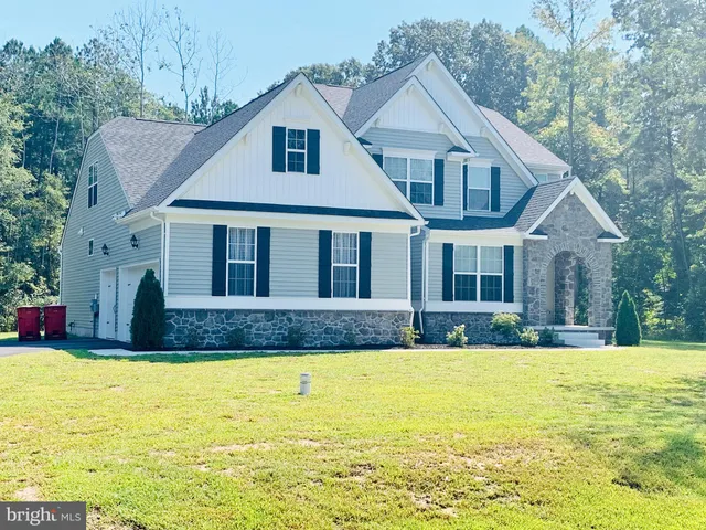 a view of a white house with a large swimming pool