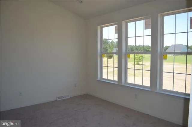a view of empty room with a fireplace
