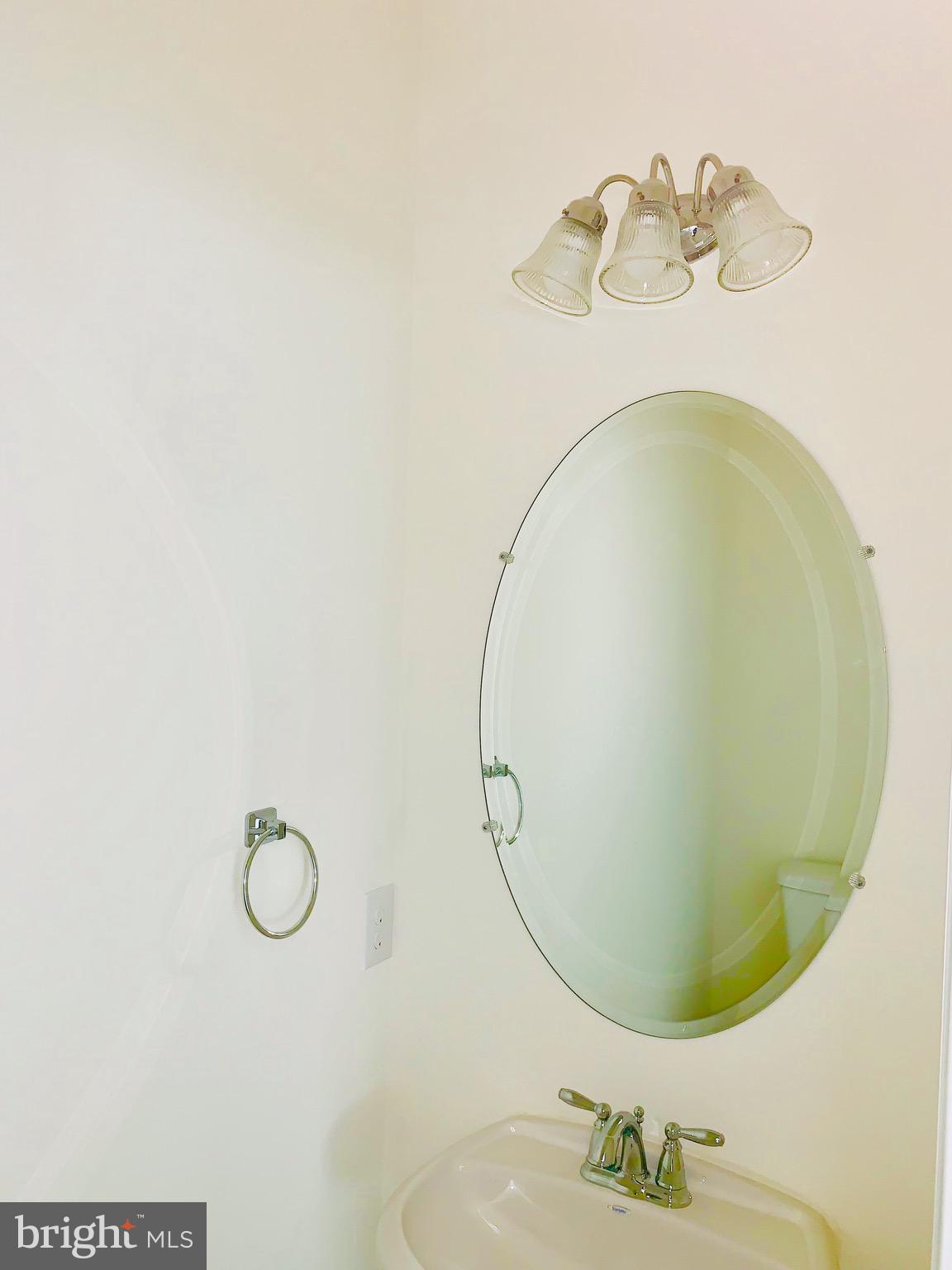 10 Patriots Way Georgetown, DE 19947 - Photo 55 of 56 a bathroom with a sink mirror and vanity