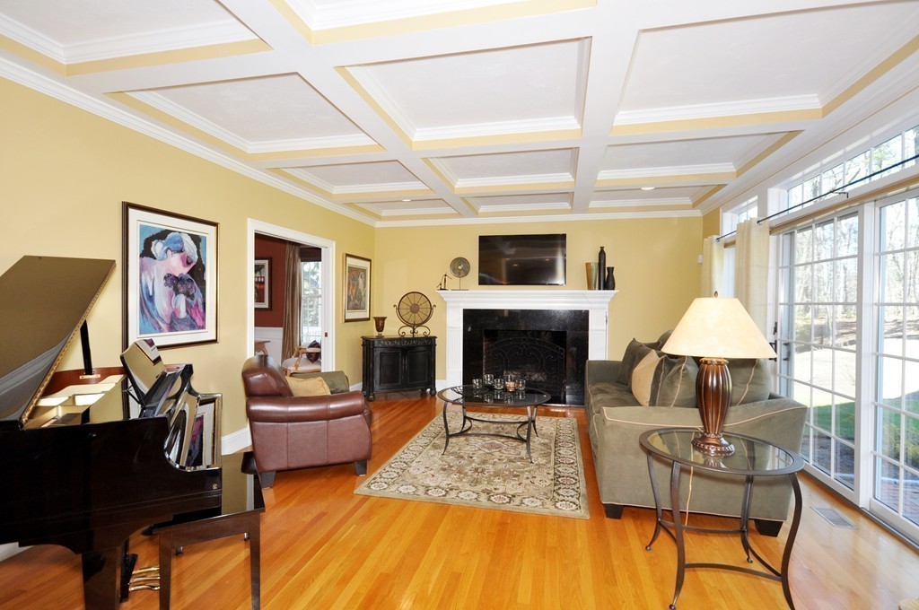 159 Fox Run Road Bolton, MA 01740 - Photo 12 of 30 a living room with furniture a fireplace and a flat screen tv
