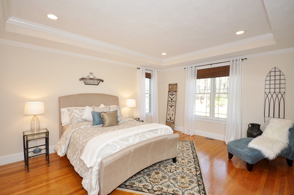 159 Fox Run Road Bolton, MA 01740 - Photo 15 of 30 a bedroom with a bed and wooden floor