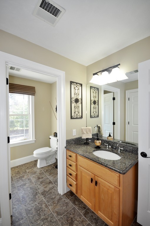 159 Fox Run Road Bolton, MA 01740 - Photo 27 of 30 a spacious bathroom with a granite countertop sink and a mirror