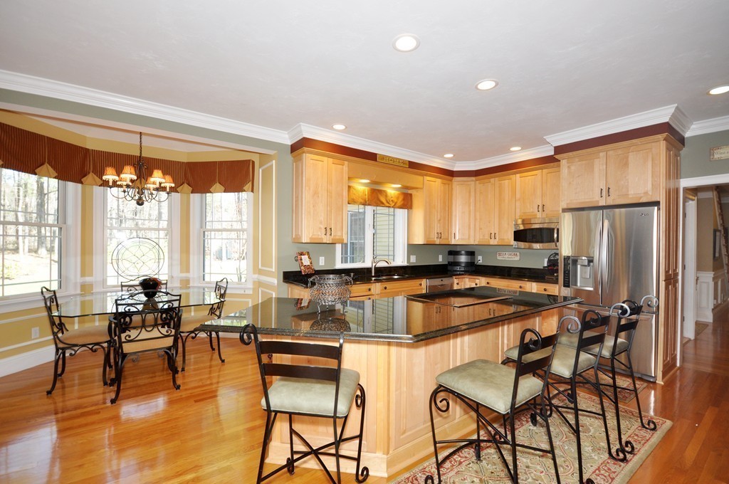 159 Fox Run Road Bolton, MA 01740 - Photo 8 of 30 a kitchen with stainless steel appliances granite countertop dining table chairs refrigerator and sink