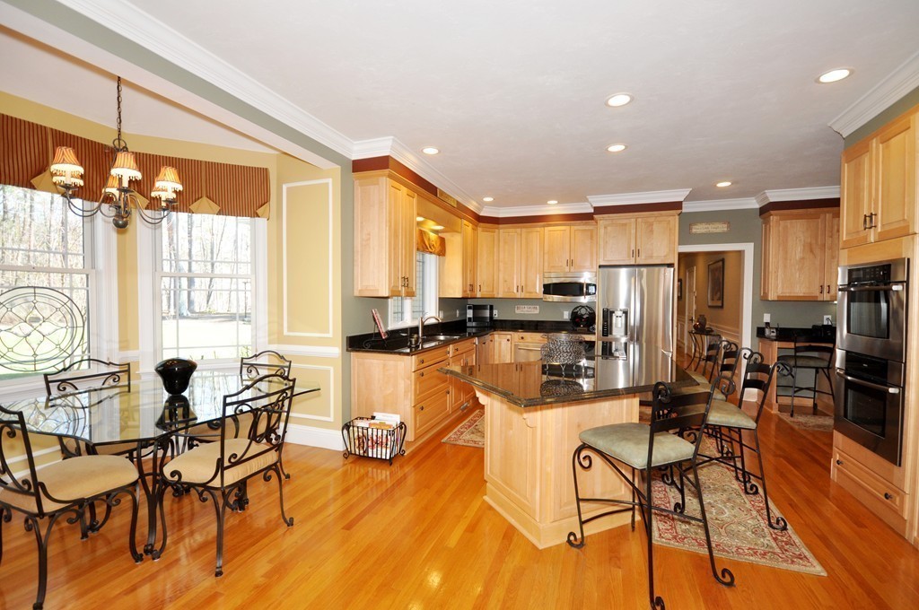 159 Fox Run Road Bolton, MA 01740 - Photo 10 of 30 a view of a dining room with furniture and a chandelier