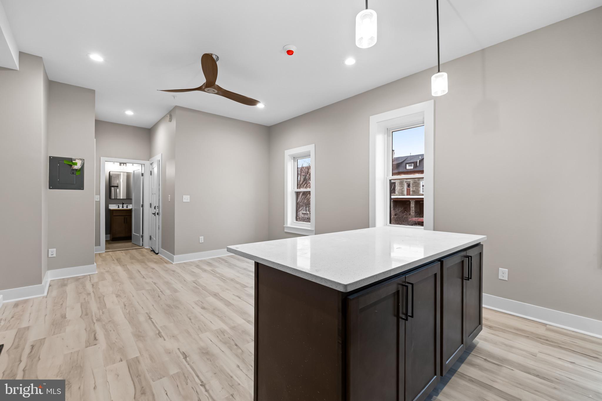 400 South Conkling Street, Unit 1 Baltimore, MD 21224 - Photo 6 of 18 a kitchen with a wooden floor and electric appliances