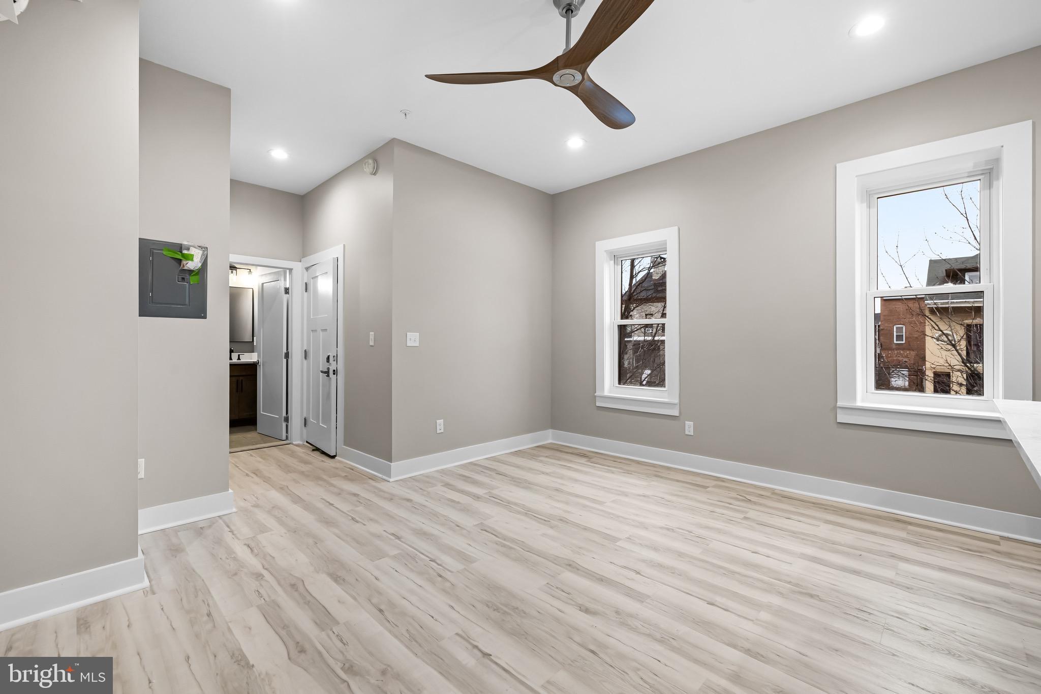 400 South Conkling Street, Unit 1 Baltimore, MD 21224 - Photo 8 of 18 a view of an empty room with wooden floor and a window