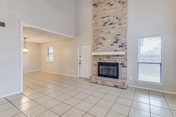 a view of a livingroom with a fireplace and window