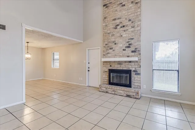 a view of a livingroom with a fireplace and window
