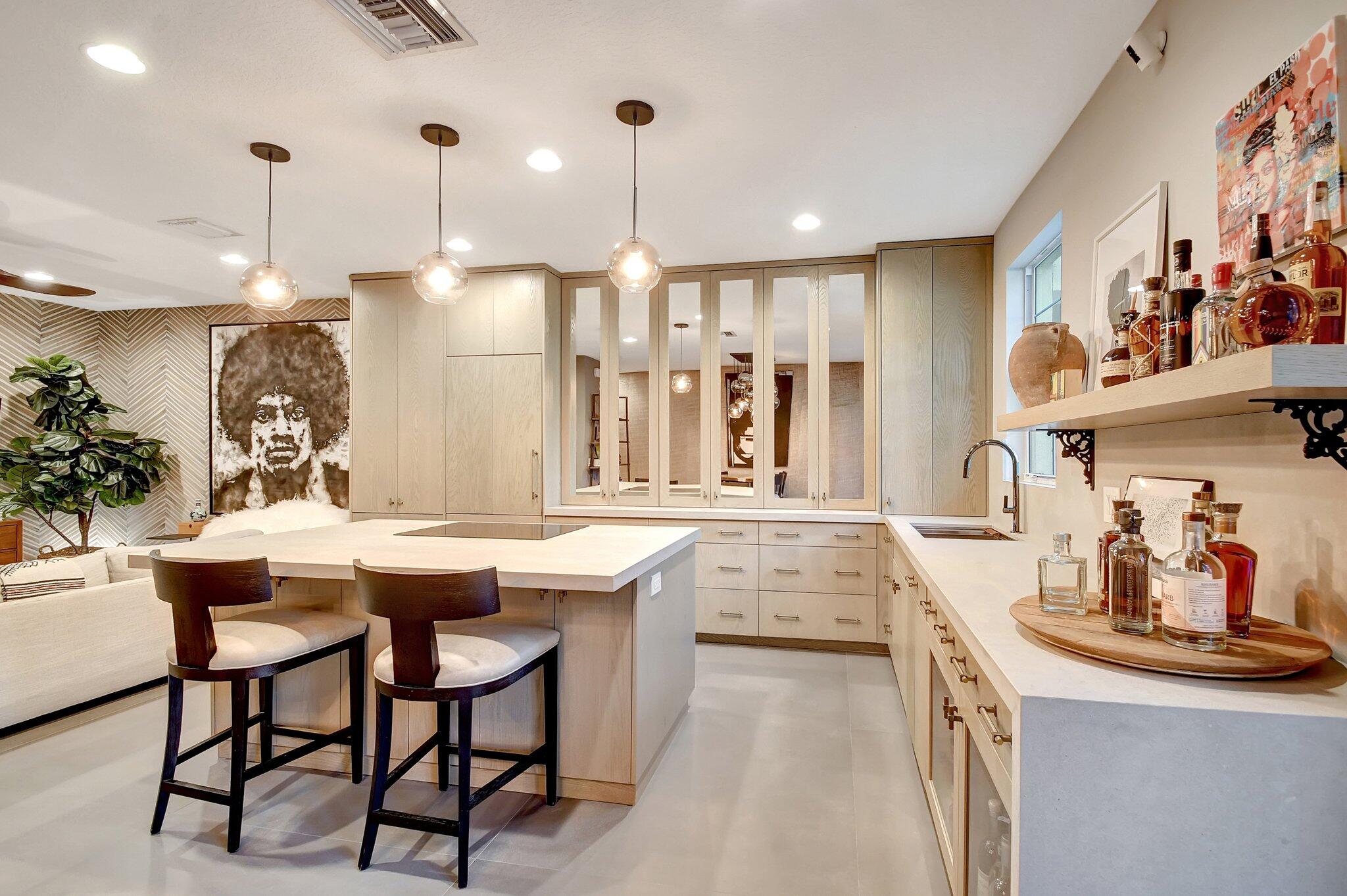 a kitchen with stainless steel appliances kitchen island a table and chairs in it