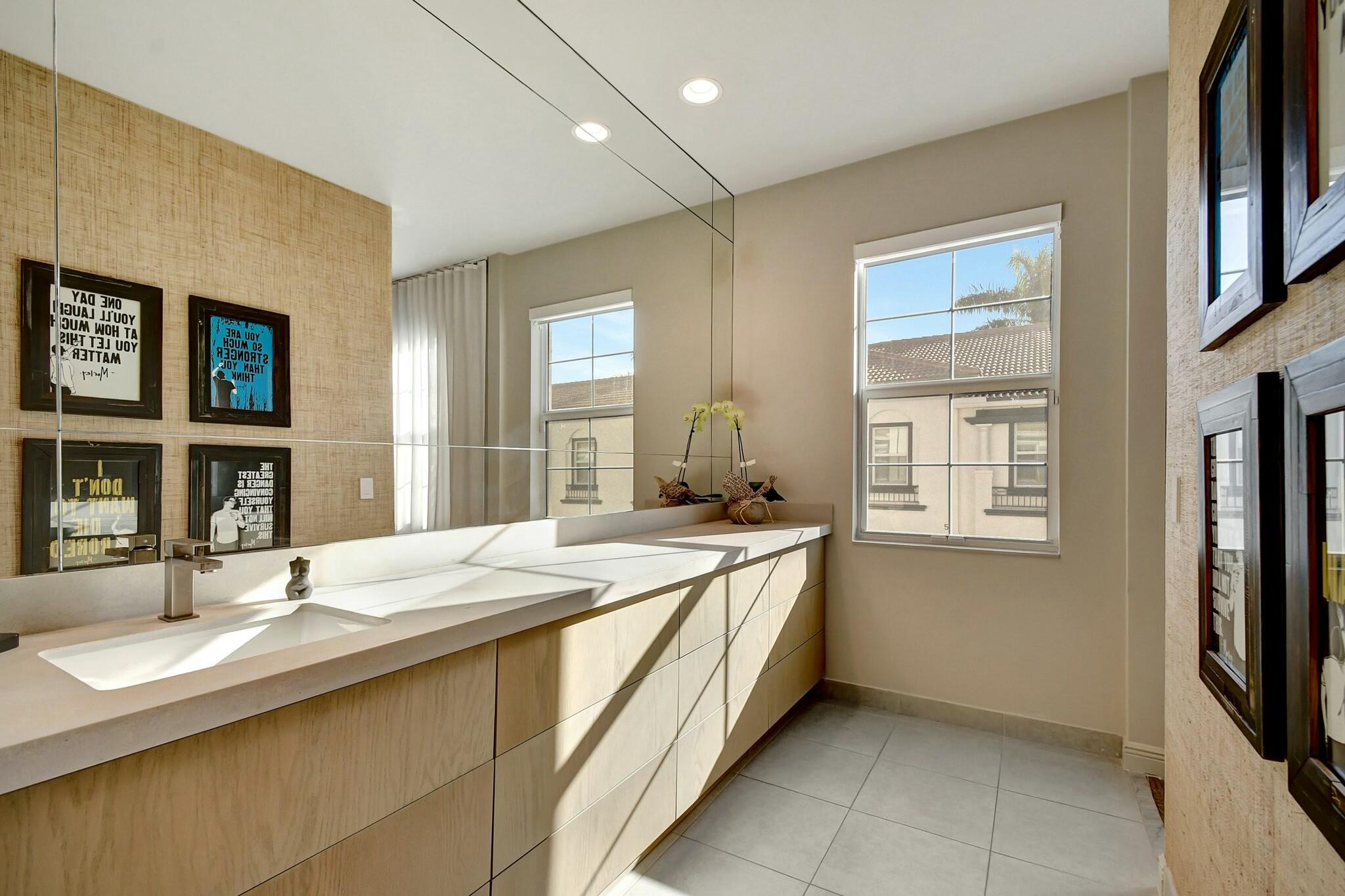 3110 Waterside Circle Boynton Beach, FL 33435 - Photo 11 of 40 a spacious bathroom with a granite countertop sink and a large mirror