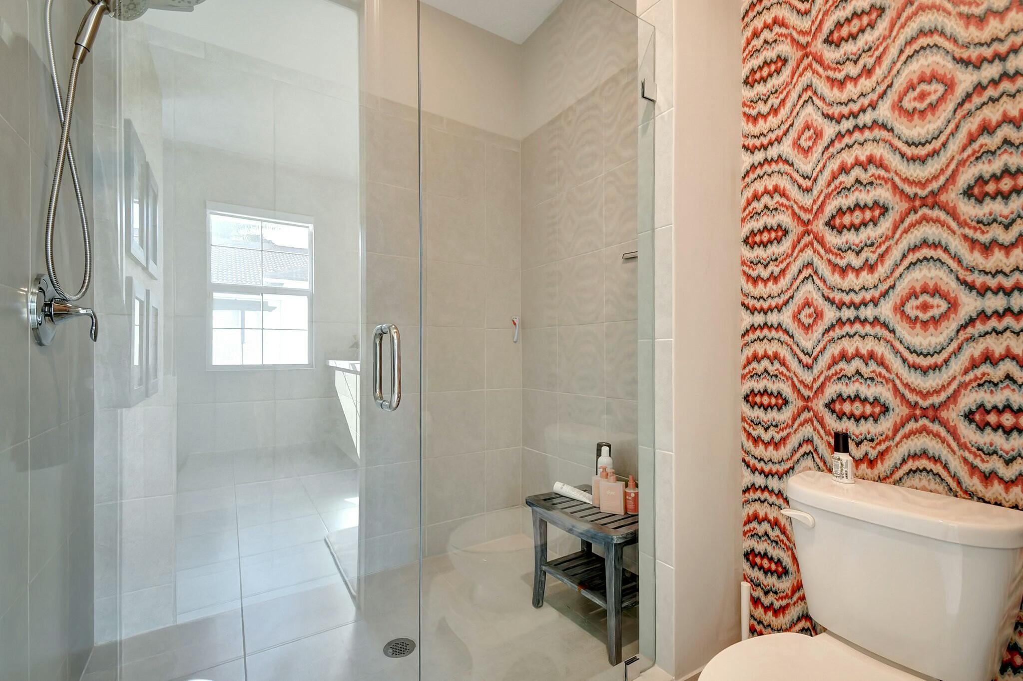 3110 Waterside Circle Boynton Beach, FL 33435 - Photo 12 of 40 a bathroom with a toilet and a shower curtain