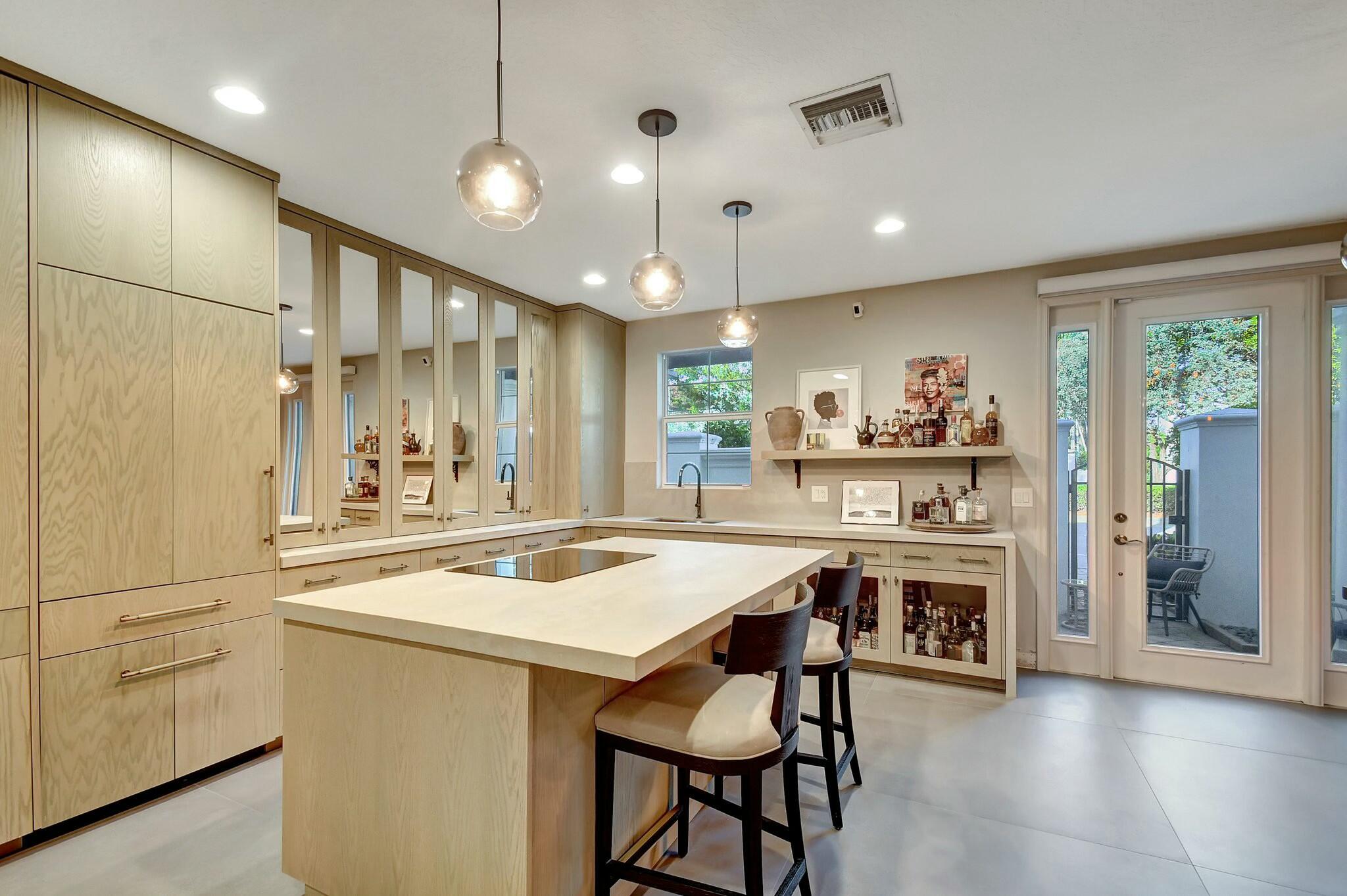 3110 Waterside Circle Boynton Beach, FL 33435 - Photo 2 of 40 a kitchen with kitchen island a stove a table and chairs in it