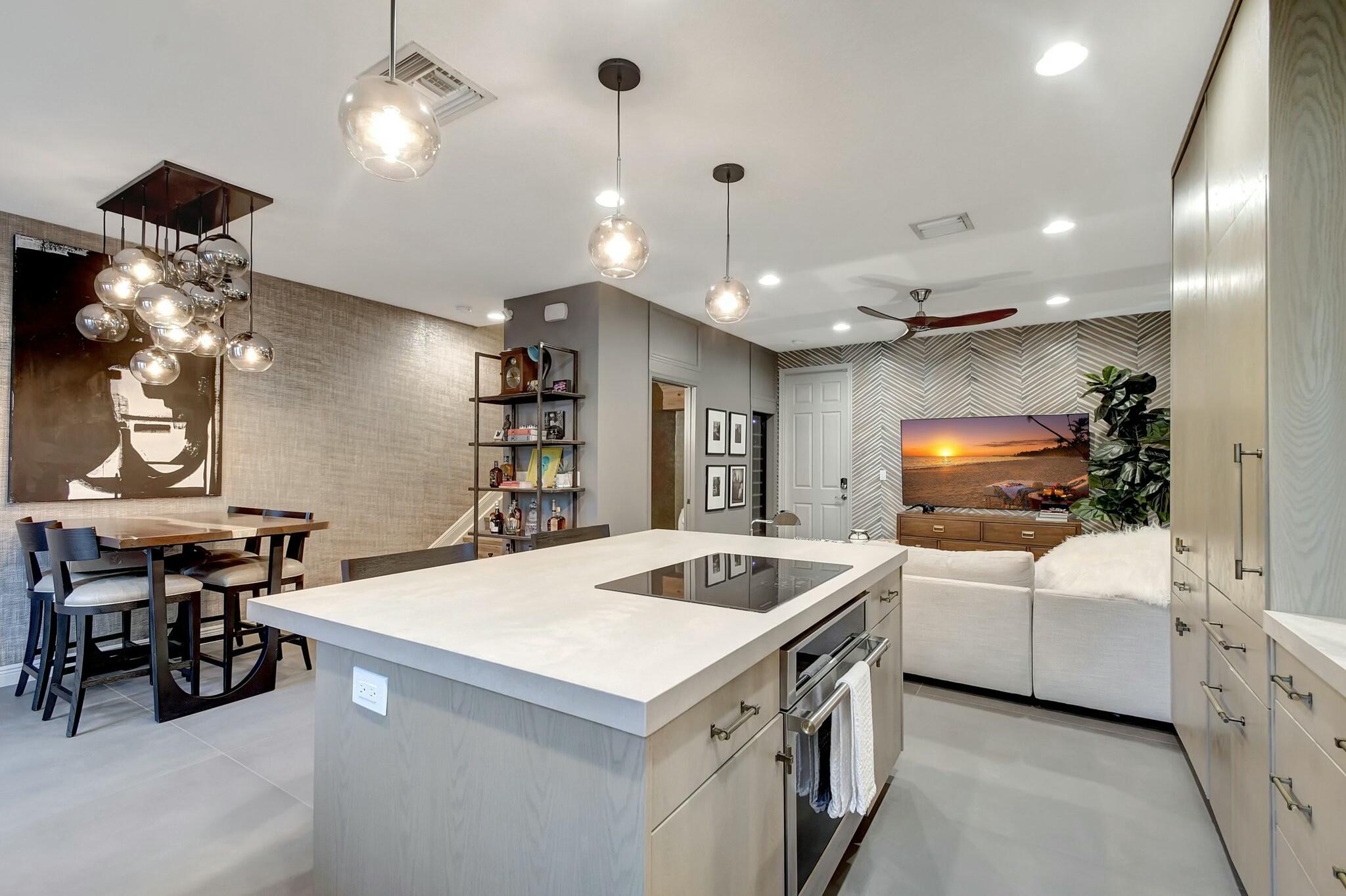 3110 Waterside Circle Boynton Beach, FL 33435 - Photo 3 of 40 a kitchen with a sink a counter space appliances and a chandelier