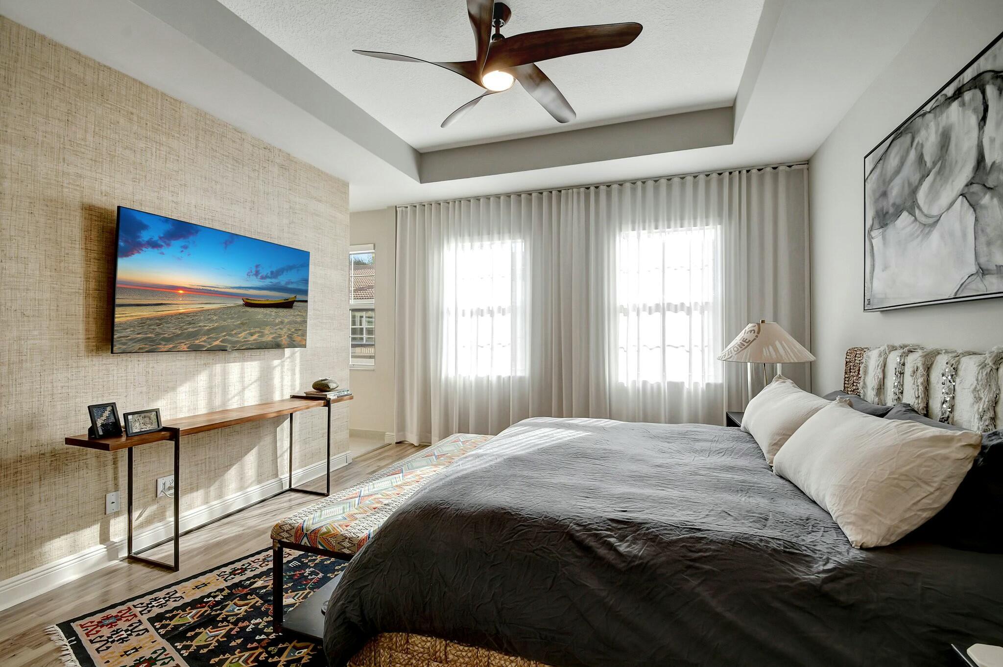 3110 Waterside Circle Boynton Beach, FL 33435 - Photo 8 of 40 a bedroom with a bed and a flat screen tv