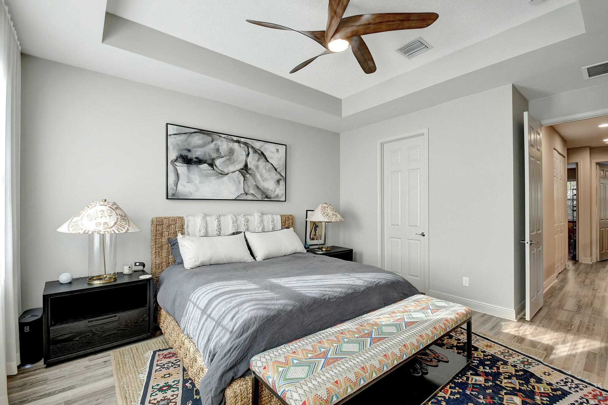 3110 Waterside Circle Boynton Beach, FL 33435 - Photo 9 of 40 a bedroom with a bed and a chandelier