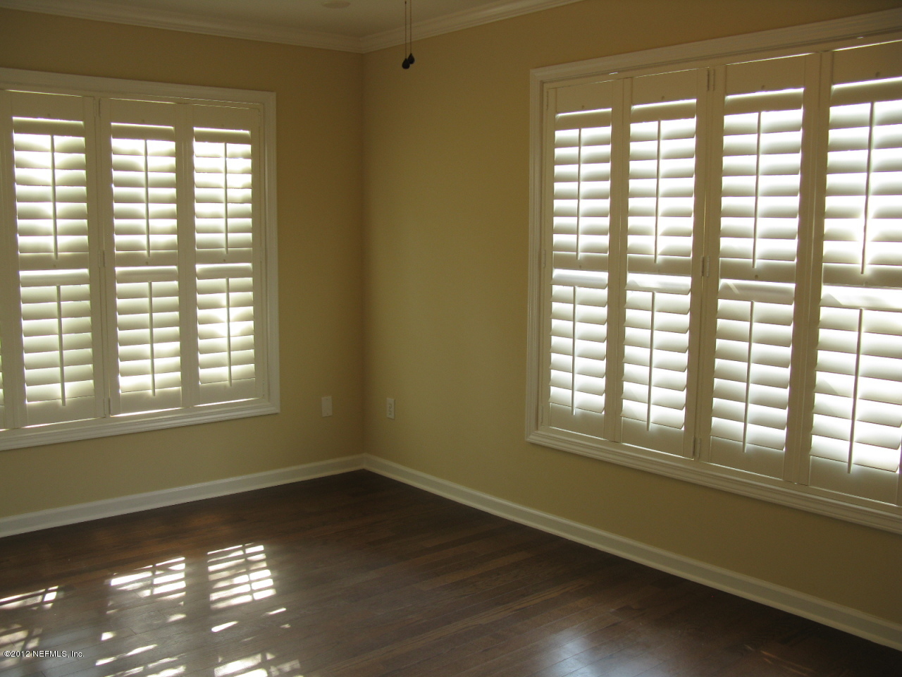 5428 Stanford Road Jacksonville, FL 32207 - Photo 13 of 20 a view of an empty room with wooden floor and a window