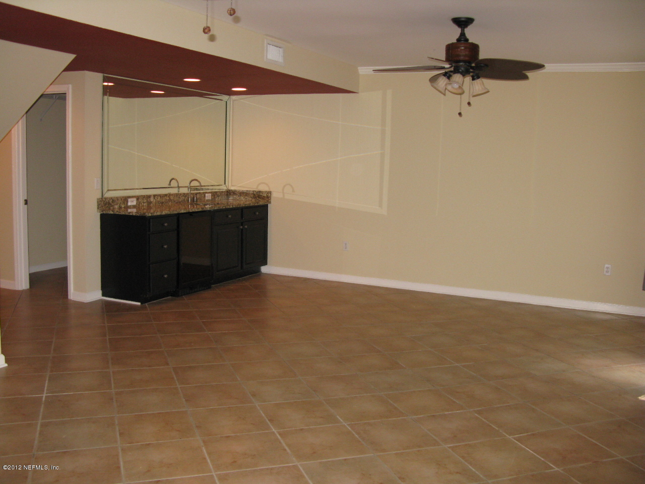 5428 Stanford Road Jacksonville, FL 32207 - Photo 17 of 20 a bathroom with a granite countertop sink a mirror and a shower
