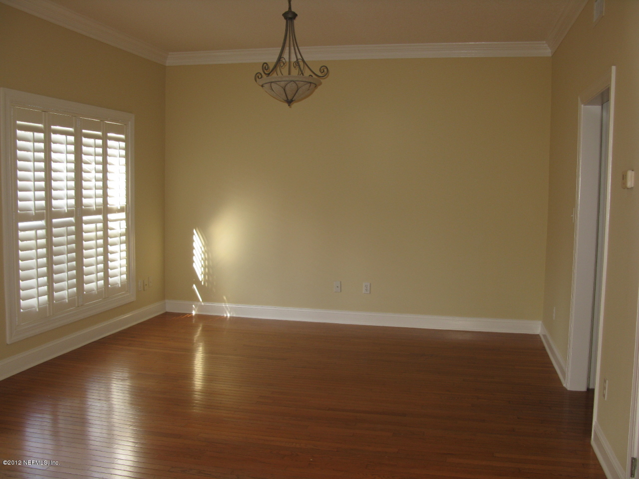 5428 Stanford Road Jacksonville, FL 32207 - Photo 6 of 20 wooden floor in an empty room with a window