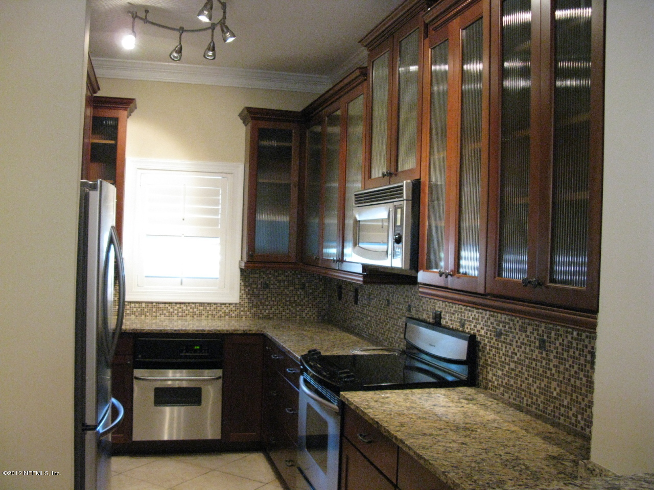 5428 Stanford Road Jacksonville, FL 32207 - Photo 8 of 20 a kitchen with granite countertop a sink and a stove